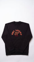 A black crewneck sweatshirt with 'GET LUCK 07' and 'LONDON MADE' embropidered in reds arched text on the chest, laid flat against a white background.