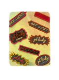 A rectangular card or coaster featuring multiple colorful 'get lucky' text badges in various shapes like stars, ovals, and banners, printed on a textured light green background.